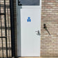 White fire rated door with a blue sign on a brick wall