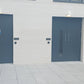 Two blue fire rated doors on a white building facade 