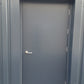 Gray metal fire rated door on a storage unit with a visible handle.